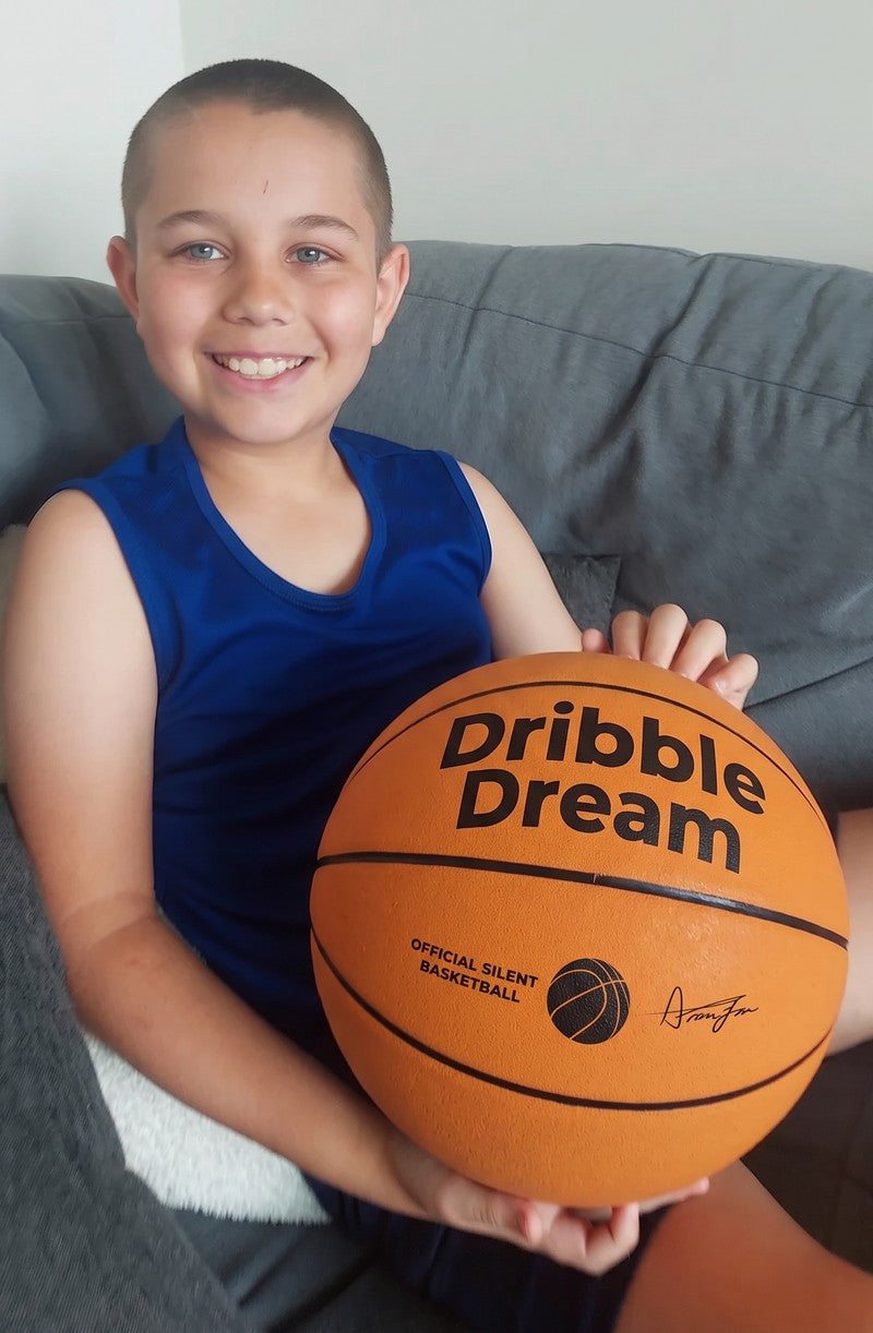 Boy on the couch with a Dribble Dream basketball