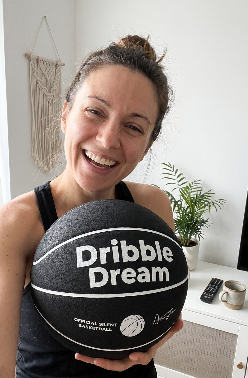 AI preview image, not a customer photo: woman holding the black Dribble Dream silent basketball